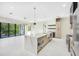 Open kitchen with a large marble island, stainless steel appliances, and plenty of natural light at 1741 Nevada Ne Ave, St Petersburg, FL 33703