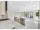 Bright, open-concept kitchen with marble island, stainless steel appliances, and sliding doors to the outside at 1741 Nevada Ne Ave, St Petersburg, FL 33703