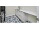 Laundry room featuring stylish blue-patterned tile and white countertops at 1741 Nevada Ne Ave, St Petersburg, FL 33703