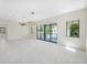 Bright living room with sliding glass doors and modern lighting fixtures at 1741 Nevada Ne Ave, St Petersburg, FL 33703