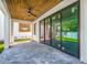 Covered patio with stained wooden ceiling, ceiling fan, modern sliding glass doors, and outdoor space at 1741 Nevada Ne Ave, St Petersburg, FL 33703