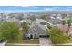 A high aerial shows the neighborhood and a home with a three-car garage, stone accents, and landscaping at 18413 Eastwyck Dr, Tampa, FL 33647