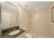 Bright bathroom features a granite vanity, toilet and a modern walk-in shower at 18413 Eastwyck Dr, Tampa, FL 33647