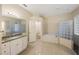 Bright bathroom features a soaking tub, glass block window, and granite vanity at 18413 Eastwyck Dr, Tampa, FL 33647