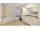 Bright bathroom features a soaking tub, glass block window, and granite vanity at 18413 Eastwyck Dr, Tampa, FL 33647