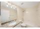 Bright bathroom features a granite vanity, toilet and a shower with a tub at 18413 Eastwyck Dr, Tampa, FL 33647