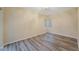 Neutral bedroom featuring wood floors and bright natural light from the two windows at 18413 Eastwyck Dr, Tampa, FL 33647