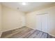 A minimalist bedroom is highlighted with modern laminate flooring and a spacious closet at 18413 Eastwyck Dr, Tampa, FL 33647