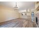 Expansive living room featuring wood floors and an open layout towards the kitchen and front entry at 18413 Eastwyck Dr, Tampa, FL 33647