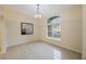 Neutral living area featuring tile flooring, a modern chandelier, and a bright window at 18413 Eastwyck Dr, Tampa, FL 33647