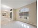 Living area with lots of light, tile flooring, a front door, and a large bright window at 18413 Eastwyck Dr, Tampa, FL 33647