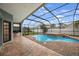 Relax in the screened-in pool and patio area, complete with an outdoor kitchen at 18413 Eastwyck Dr, Tampa, FL 33647