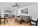 Cozy living room with modern furniture and decor, including a gray sofa, wooden chest, and ceiling fan at 1978 Arvis W Cir, Clearwater, FL 33764