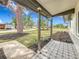 Inviting covered porch with decorative tiling, offering a charming view of the landscaped front yard at 1991 67Th S Ave, St Petersburg, FL 33712