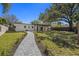 An extended custom paver walkway leads to a well manicured yard and an outdoor living space at 2117 S West Shore Blvd, Tampa, FL 33629