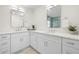 Bathroom boasts double vanity with white cabinets, quartz countertop, and modern fixtures at 2117 S West Shore Blvd, Tampa, FL 33629