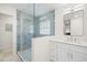 The tiled walk-in shower features a rainfall shower head and seamless glass doors at 2117 S West Shore Blvd, Tampa, FL 33629