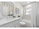 Traditional bathroom features a tub/shower combo, vanity and decorative mirror with light at 2117 S West Shore Blvd, Tampa, FL 33629