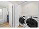 This laundry room features a stacked washer/dryer and a laundry sink with blue cabinetry at 2117 S West Shore Blvd, Tampa, FL 33629