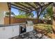 An outdoor kitchen features granite countertops, a stainless steel grill, and an outdoor fridge at 2117 S West Shore Blvd, Tampa, FL 33629