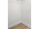 The image shows a corner of a walk-in closet with wood floor and white walls and trim at 2117 S West Shore Blvd, Tampa, FL 33629
