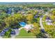 Beautiful aerial view of a community pool and clubhouse, surrounded by mature trees in a tranquil neighborhood at 2124 Crowsnest Dr, Palm Harbor, FL 34685