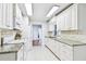 Spacious kitchen with granite countertops, white appliances, and ample cabinet space at 2124 Crowsnest Dr, Palm Harbor, FL 34685