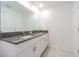 Bathroom with granite countertops, double sinks, and white cabinets offering ample storage at 21385 Darter Rd, Land O Lakes, FL 34638