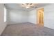 Spacious bedroom with ceiling fan, neutral carpet, and a large window for ample natural light at 21385 Darter Rd, Land O Lakes, FL 34638