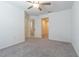 Bright bedroom with neutral carpet, ample natural light, and multiple access doors at 21385 Darter Rd, Land O Lakes, FL 34638