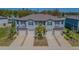 Inviting townhome exterior with a two-car garage, neutral paint, and well-maintained landscaping at 21385 Darter Rd, Land O Lakes, FL 34638