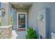 Inviting front entrance featuring stone accents, a covered porch, and a black front door at 21385 Darter Rd, Land O Lakes, FL 34638