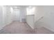 Upstairs hallway with neutral carpet, white walls, and access to bedrooms at 21385 Darter Rd, Land O Lakes, FL 34638