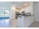Bright kitchen with white cabinets, granite countertops, stainless steel appliances, and tile flooring at 21385 Darter Rd, Land O Lakes, FL 34638