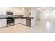 Modern kitchen with stainless steel appliances, granite countertops and access to the living space at 21385 Darter Rd, Land O Lakes, FL 34638