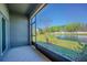 Relaxing screened-in patio with a view of the pond and green landscaping at 21385 Darter Rd, Land O Lakes, FL 34638