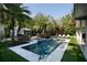 Backyard pool area with lush landscaping, lounge chairs, and a spa at 2521 Driftwood Se Rd, St Petersburg, FL 33705