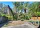 Landscaped backyard showcasing lush trees and privacy fence at 2542 Clareside Dr, Valrico, FL 33596