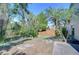 Well-maintained backyard with landscaping, complemented by palm trees and a privacy fence at 2542 Clareside Dr, Valrico, FL 33596