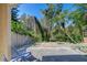 Backyard featuring a patio area, wooden fence, and lush green foliage at 2542 Clareside Dr, Valrico, FL 33596