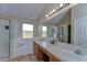 Bright bathroom featuring a double vanity, soaking tub, and separate glass-enclosed shower for a luxurious experience at 2542 Clareside Dr, Valrico, FL 33596