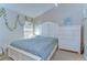 Bright bedroom featuring neutral tones, comfortable bed, and a large dresser, creating a peaceful and inviting atmosphere at 2542 Clareside Dr, Valrico, FL 33596