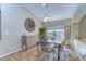Charming dining room featuring a glass-top table, unique chairs, and decorative wall clock for a warm and inviting atmosphere at 2542 Clareside Dr, Valrico, FL 33596
