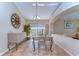 Formal dining area featuring tile floors, unique furniture, and a large clock at 2542 Clareside Dr, Valrico, FL 33596