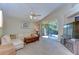 Bright living room with a white sectional couch, wooden coffee table, and sliding glass doors to the outdoor patio at 2542 Clareside Dr, Valrico, FL 33596