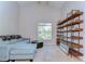 Cozy living room featuring comfortable seating, a large window with natural light, and stylish shelving for a relaxing space at 2542 Clareside Dr, Valrico, FL 33596