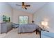 Comfortable bedroom with neutral tones, a plush bed, a large window, and ample natural light for a serene retreat at 2542 Clareside Dr, Valrico, FL 33596