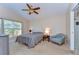 Cozy bedroom with neutral tones, a comfortable bed, a large window, and an ensuite bathroom with a glass shower at 2542 Clareside Dr, Valrico, FL 33596