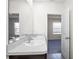 Bathroom with double vanity sinks with granite countertops and access to bedroom at 2892 Beluga Bay Dr, Odessa, FL 33556