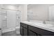 Bathroom featuring double sinks, granite countertops, and a walk-in shower at 2892 Beluga Bay Dr, Odessa, FL 33556
